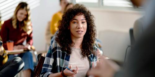 A student sitting at their desk responding to the teacher