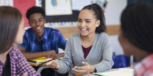 Two students speaking to each other in class