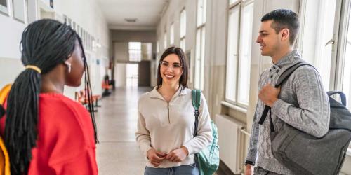 college students talking in a hallway