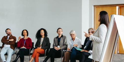 A person talking to a group of people